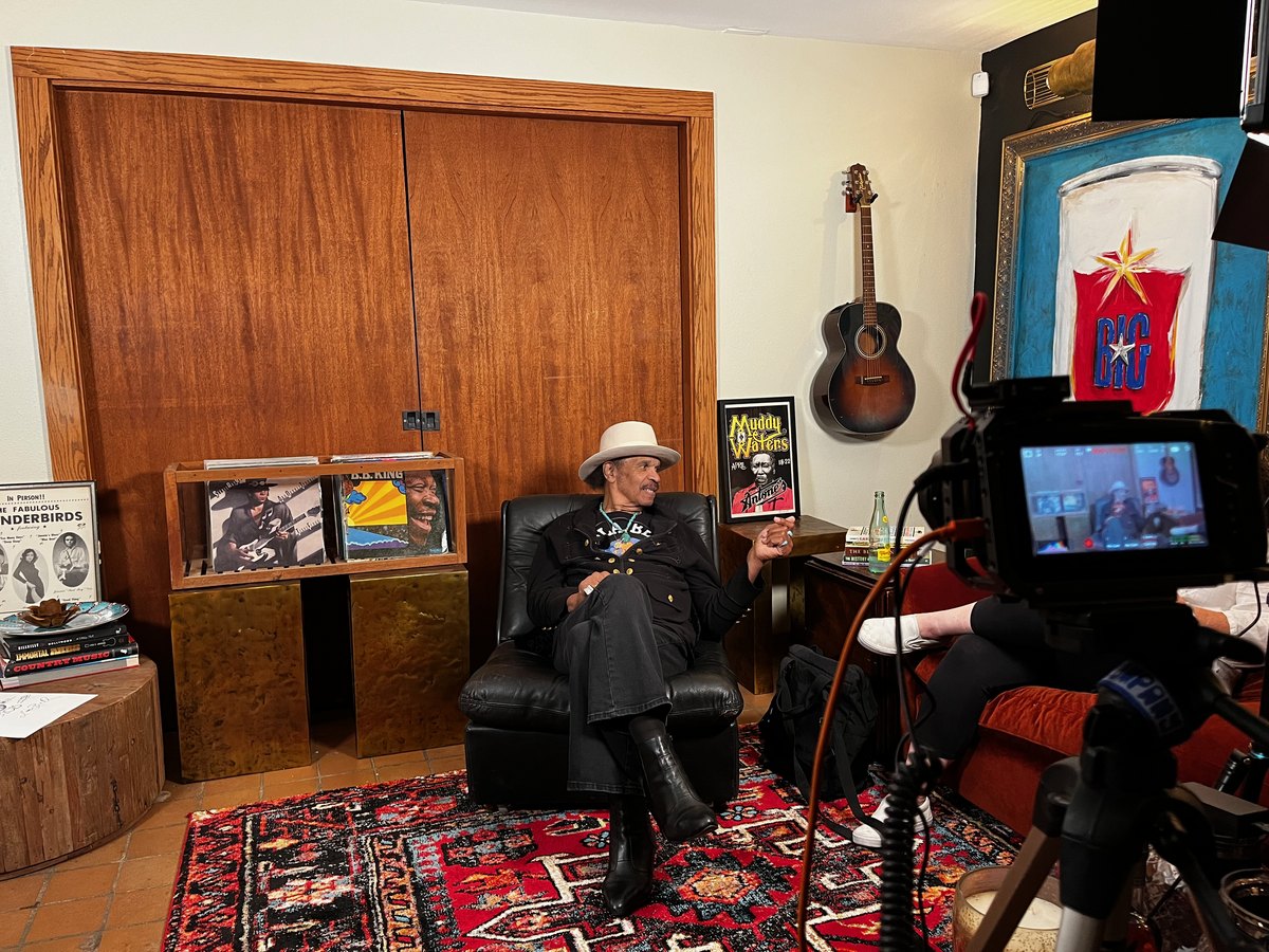 A man being filmed in his own living room for a Lifelong Legacy session
